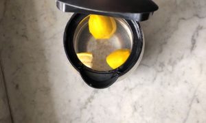 lemons in clear kettle on marble bench